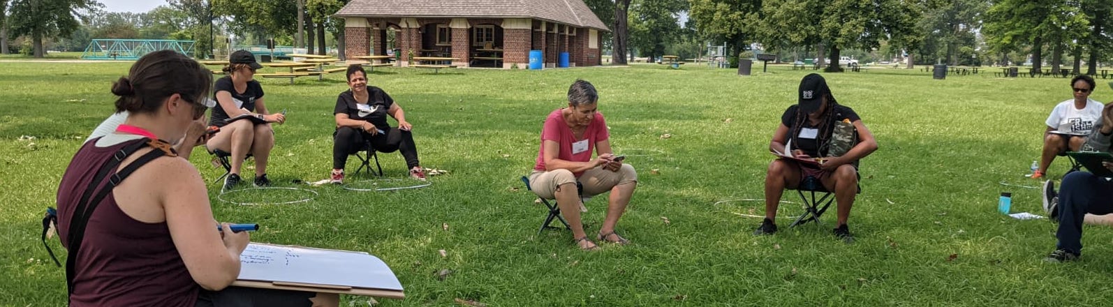 image of teachers sitting outside discussing